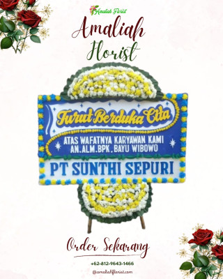 Papan Bunga Duka di Belakang Balok